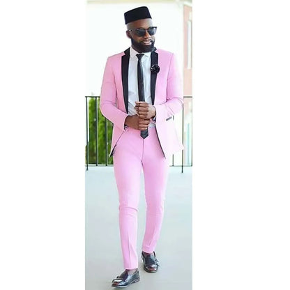Man wearing elegant slim fit pink suit with black lapels and tie, formal luxury two-piece set for special occasions