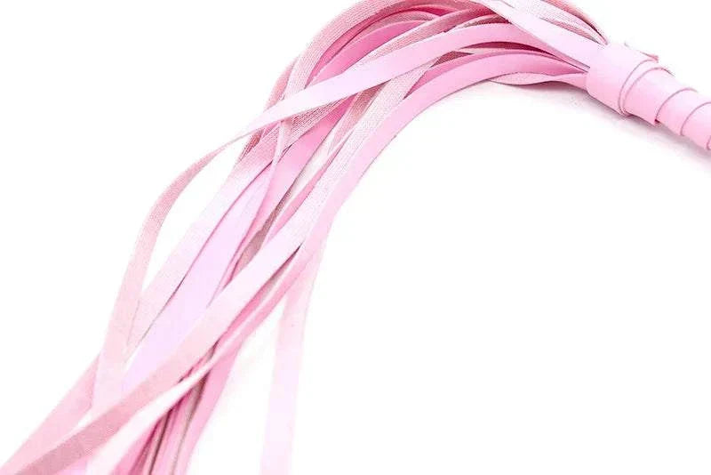 Pink leather BDSM bondage flogger with multiple tails, used for erotic spanking and adults games.