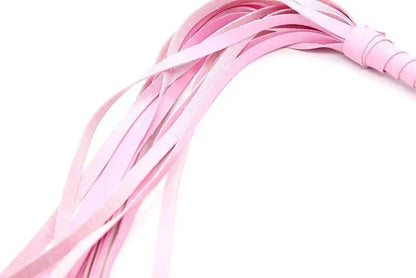Pink leather BDSM bondage flogger with multiple tails, used for erotic spanking and adults games.