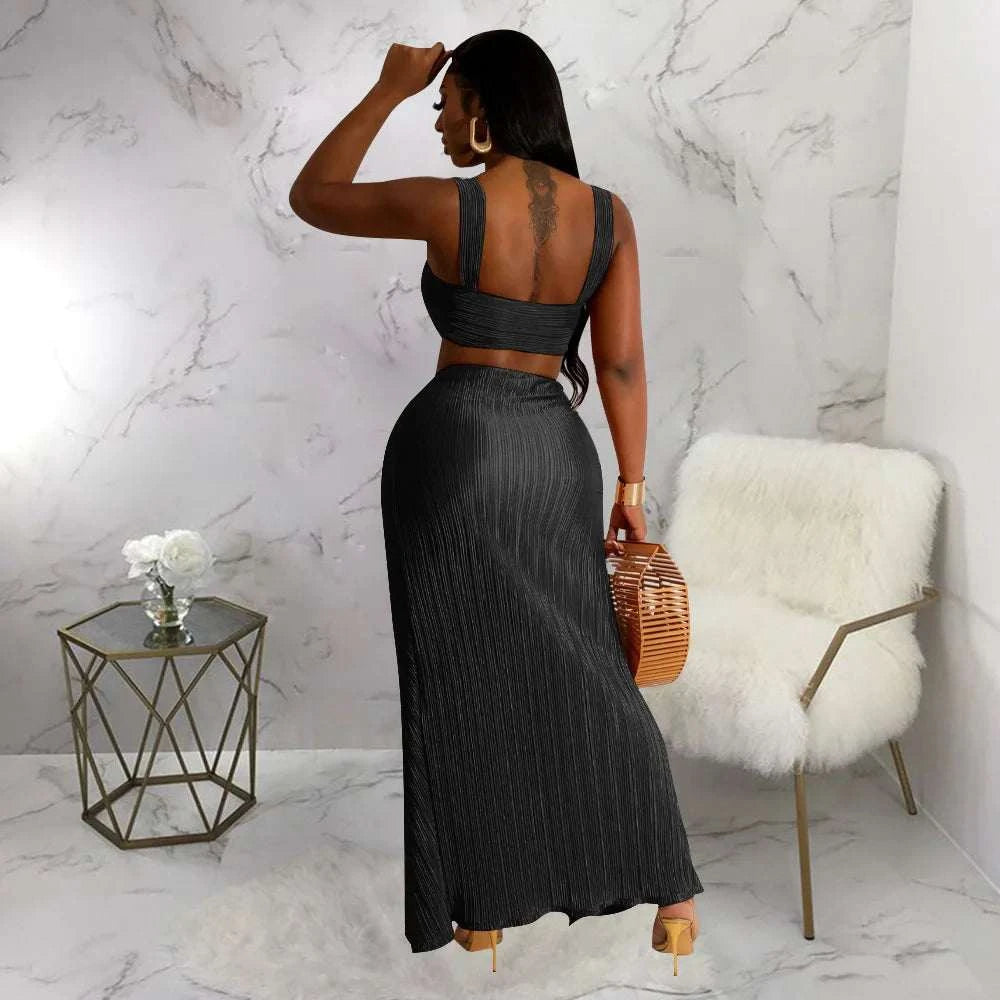 Summer two-piece set with backless halter top and high waist side slit pleated skirt in lady streetwear style.