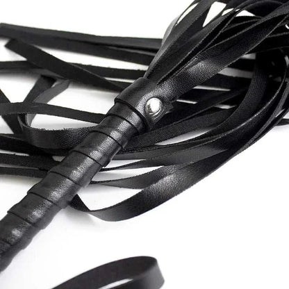 BDSM leather flogger with black handle and straps for adult erotic play.