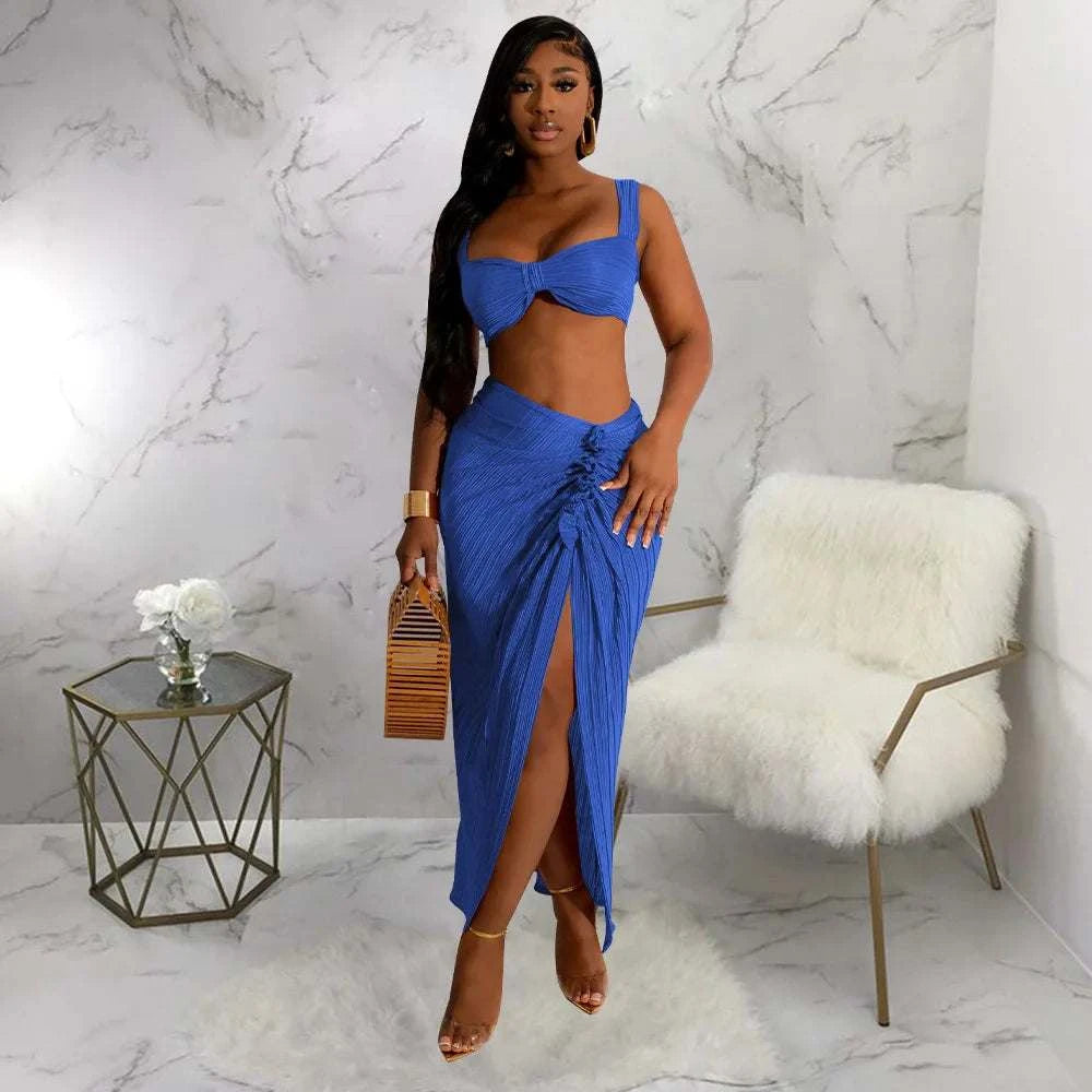 Two-piece set with backless halter top and high waist slit pleated skirt in blue, perfect for summer streetwear.