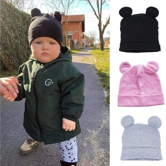 Cotton baby hat with bear ears for infants and toddlers, available in black, pink, and gray colors.