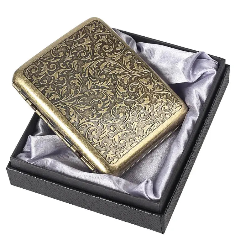 Retro cigarette box with intricate brass design in gift box.