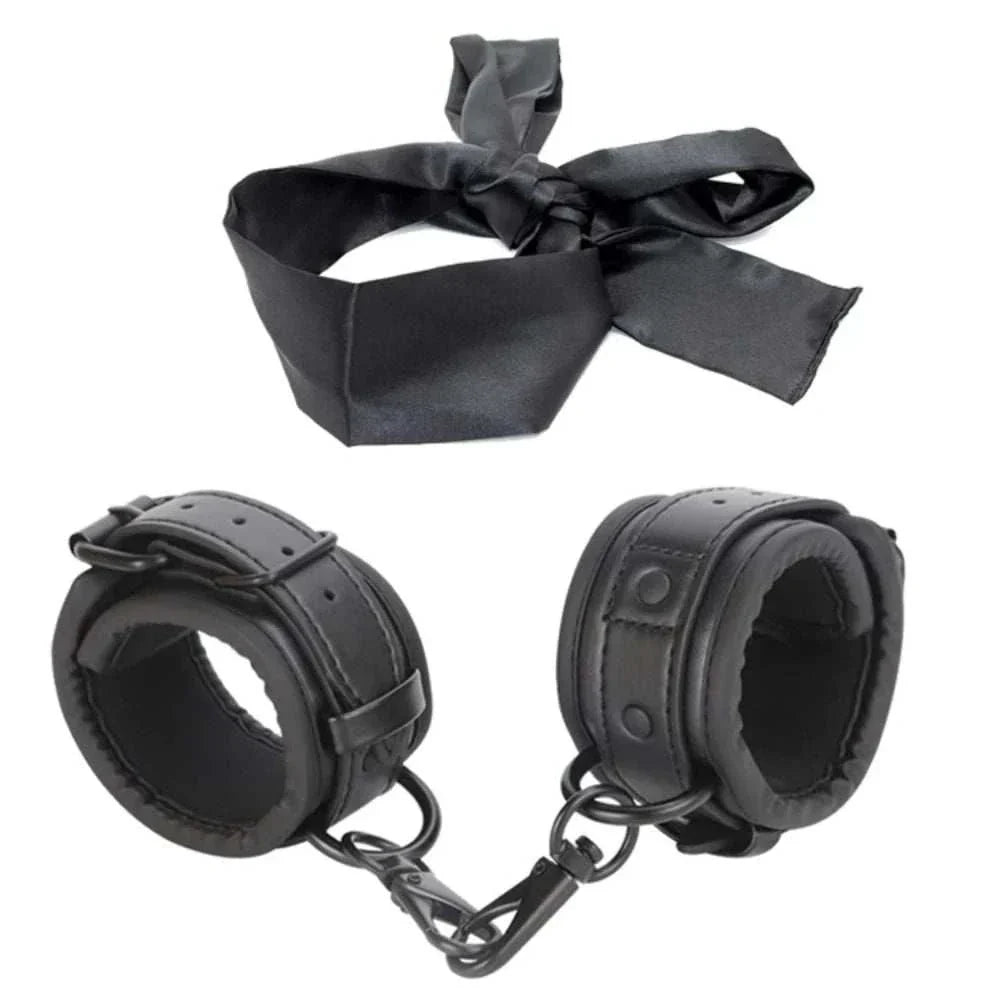 SM erotic leather handcuffs and footcuffs set for BDSM bondage play.