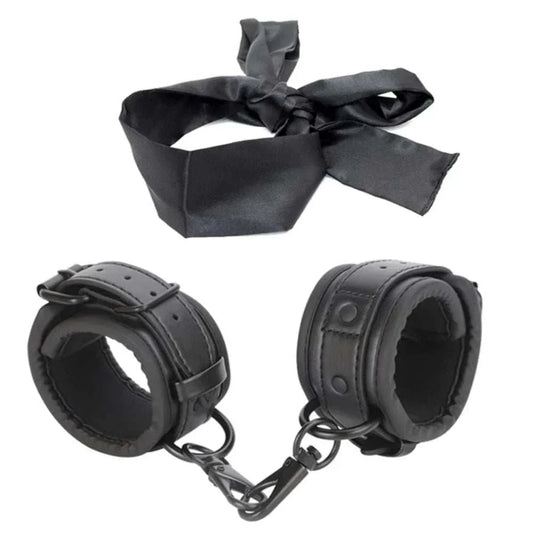 SM erotic leather handcuffs and footcuffs set for BDSM bondage play.