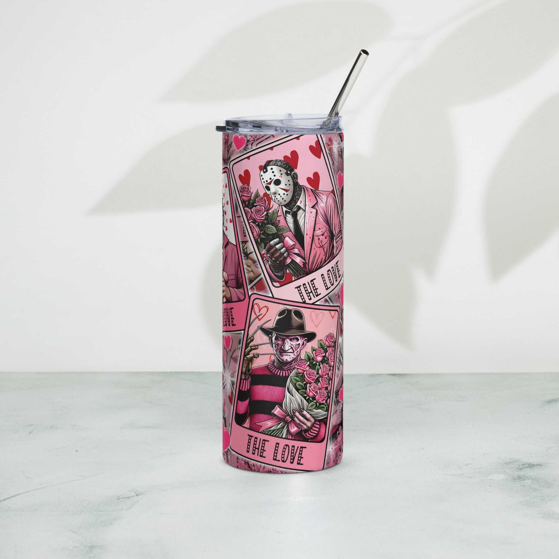 Stainless steel tumbler with metal straw and playful design, 20 oz capacity, ideal for hot or cold drinks.