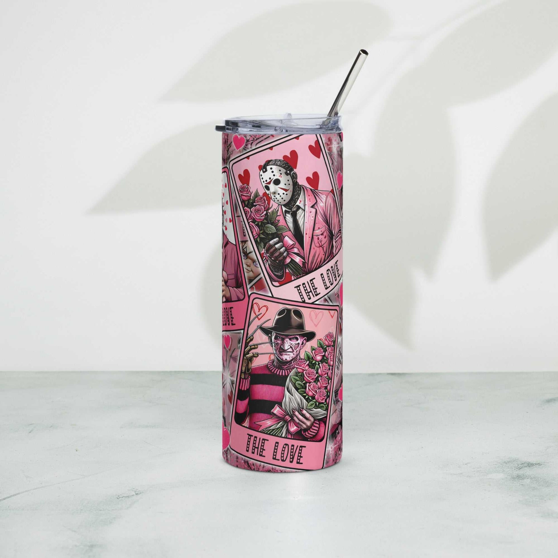 Stainless steel tumbler with decorative design and metal straw.