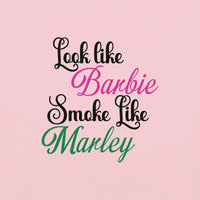 "Look like Barbie, Smoke like Marley" text on pink background t-shirt design.