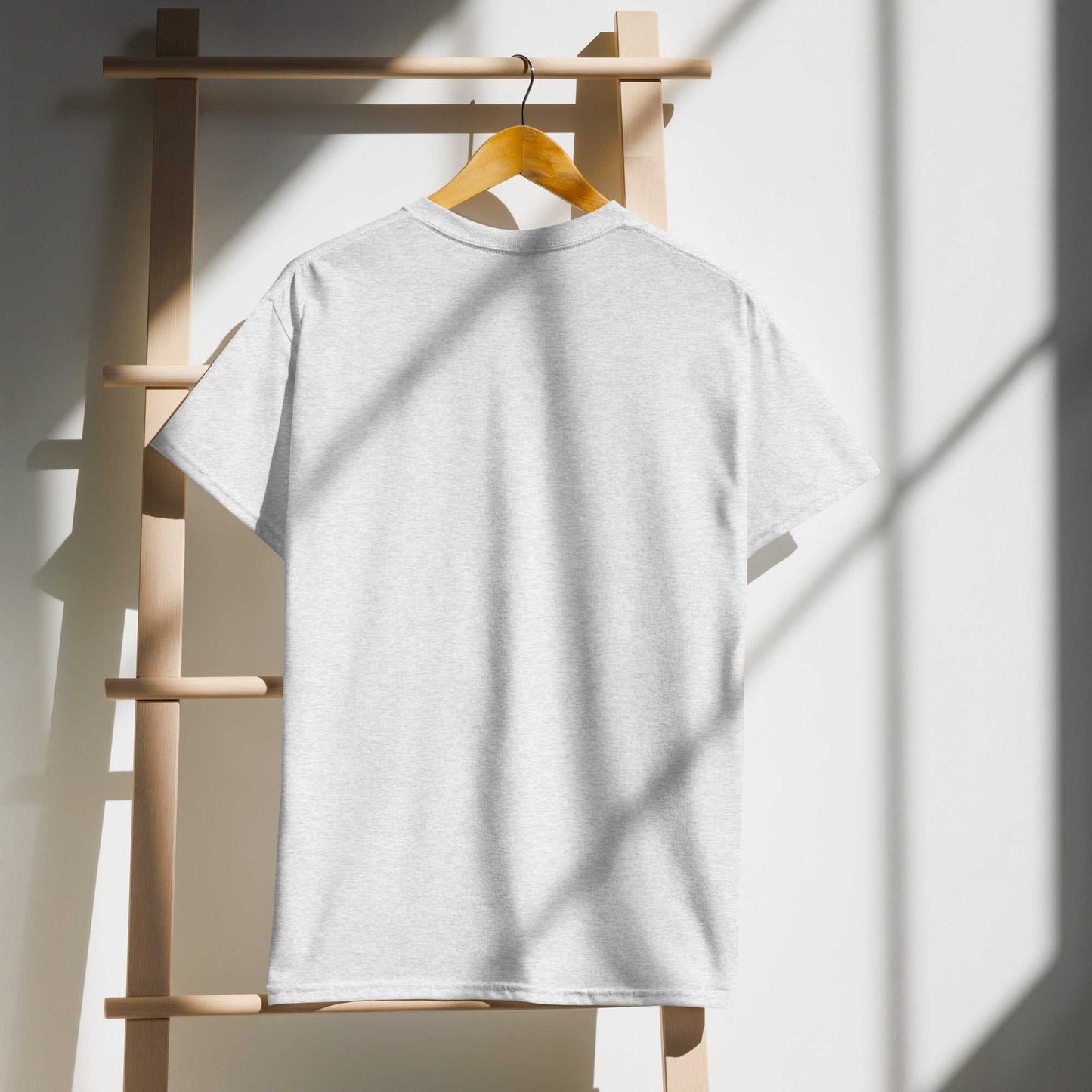 Saggin Still Gaggin DryBlend T-Shirt hanging on a wooden rack in sunlight.