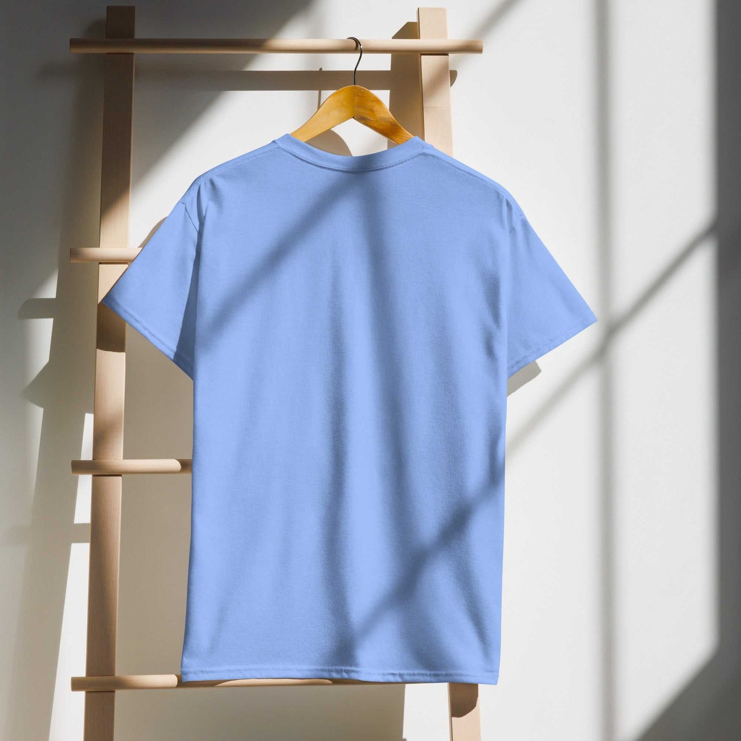 Light blue Saggin Still Gaggin DryBlend® T-Shirt hanging on a wooden ladder.