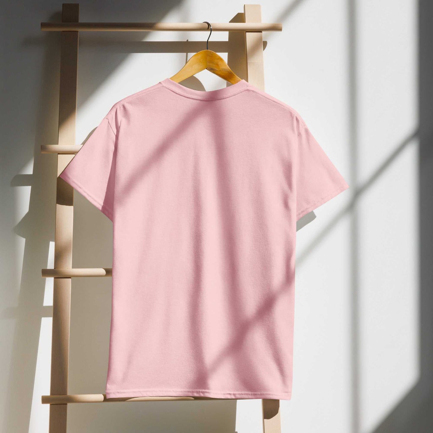 Pink Saggin Still Gaggin DryBlend T-Shirt displayed on a hanger against a minimalistic backdrop.